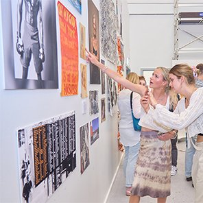 People pointing at artwork in an exhibit