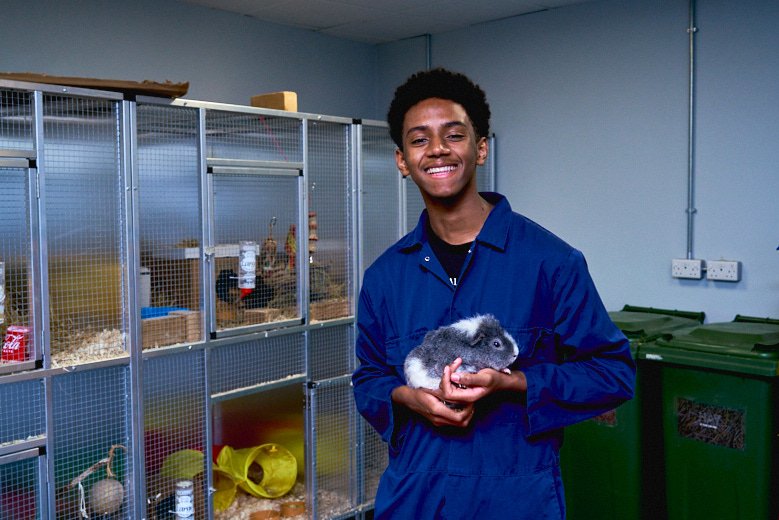 Student holding pet in Animal Management facilities